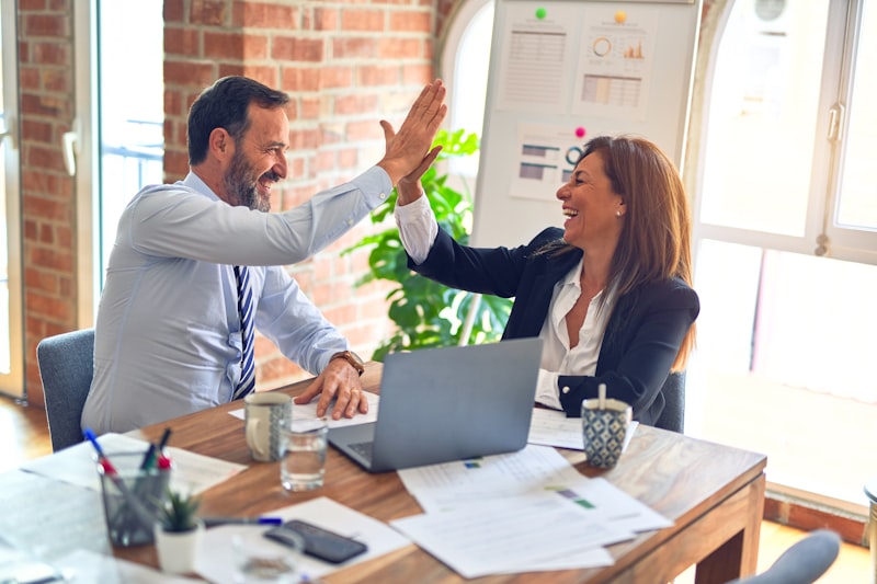 Two Pulse Marketing advisors celebrating a successful client solution